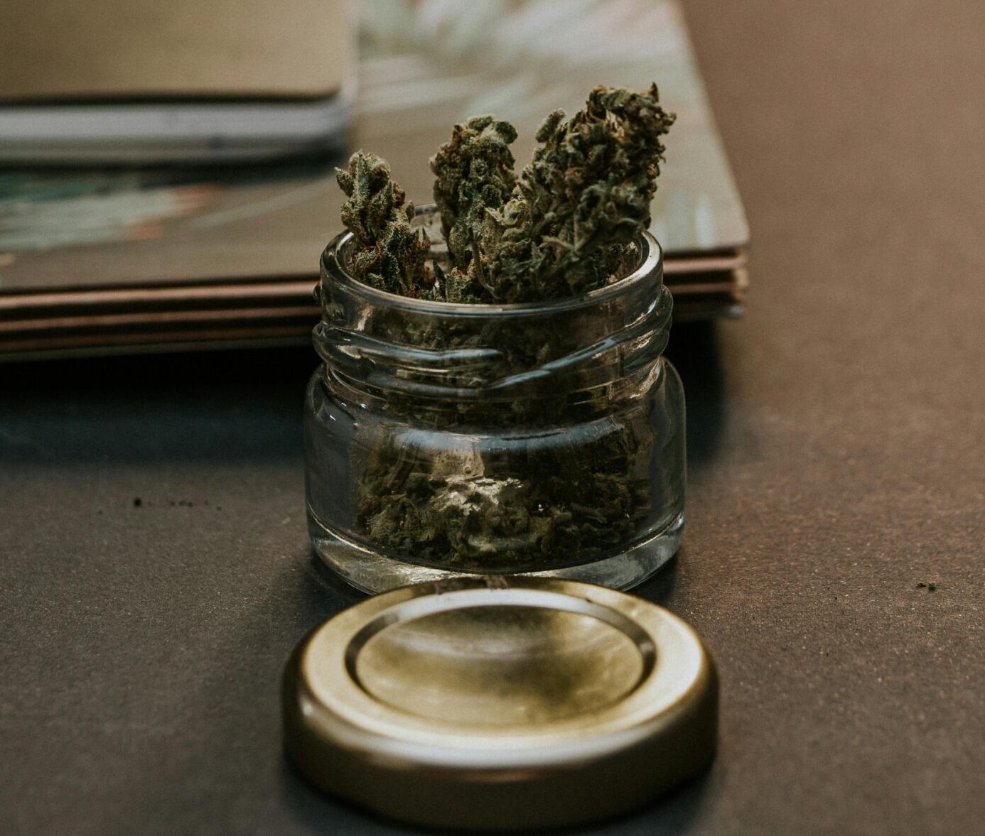 A jar of cannabis buds on a desk with notebooks in St. Catharines, after A1 Terps' cannabis delivery