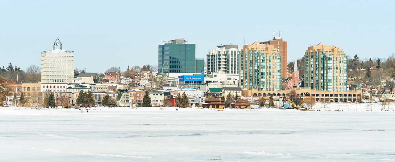Skyline of Barrie's waterfront in winter, showcasing buildings and a frozen lake, with weed delivery and cannabis delivery services available.
