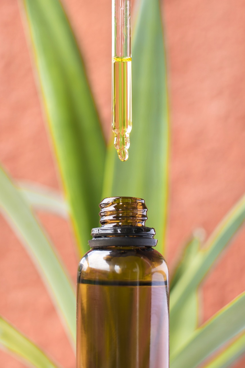 A close-up of a CBD dropper releasing oil into a glass bottle, showing how CBD oil is used after weed delivery in Kitchener-Waterloo.