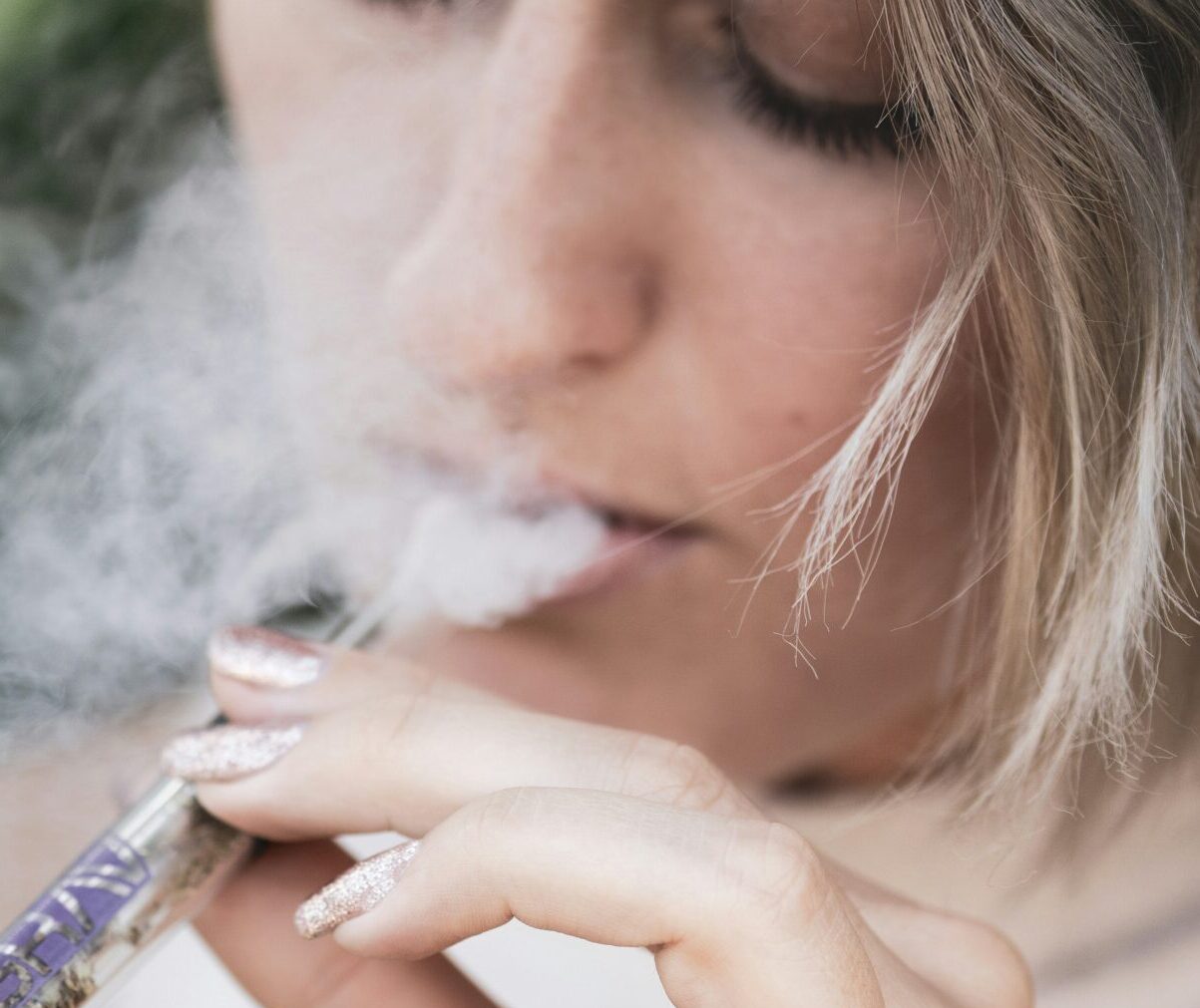Woman enjoying a THC Cartridge from A1 Terps, your trusted source for weed delivery in Vancouver.