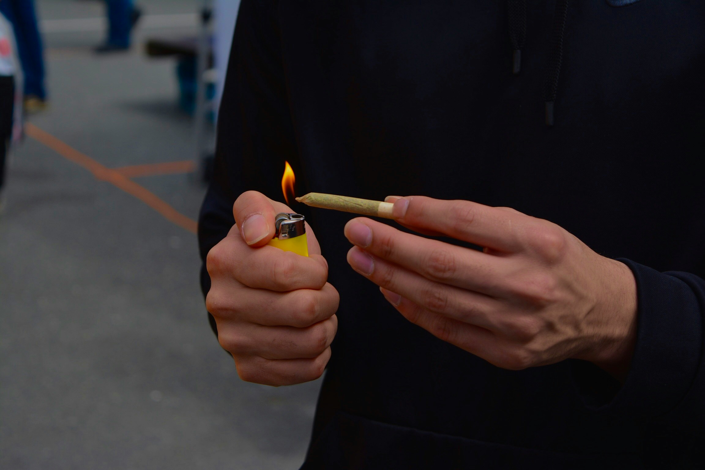 Lighting a pre-roll cannabis joint from A1 Terps, ensuring a smooth and enjoyable cannabis experience.
