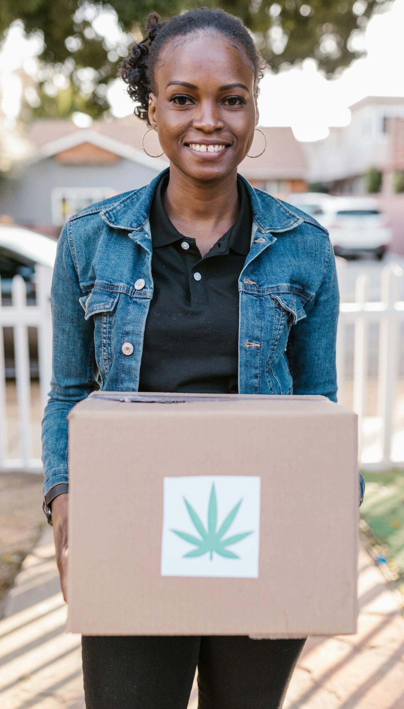 Friendly delivery person delivering a cannabis package to a customer in Toronto.
