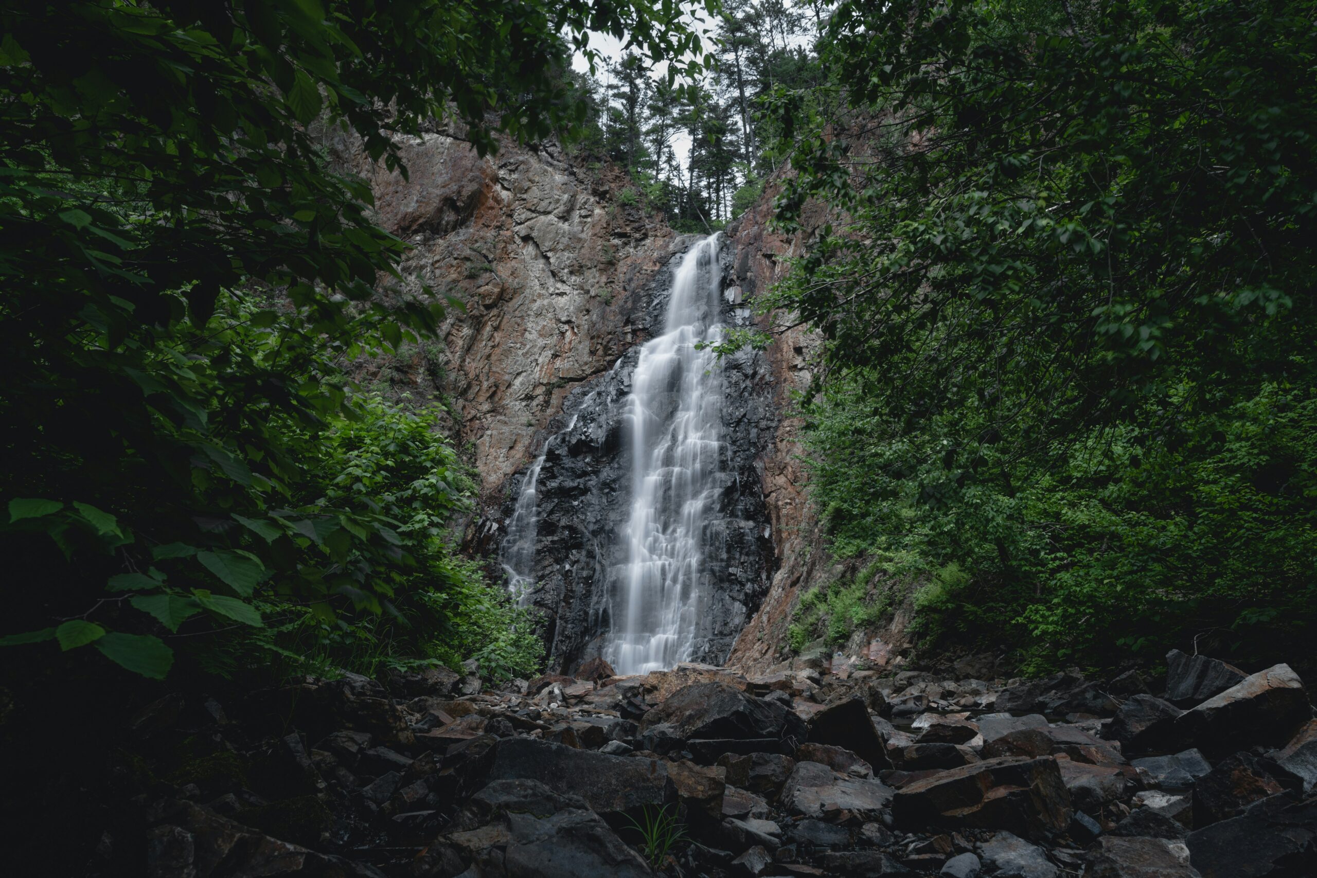 Waterfall in Fredericton's lush greenery, highlighting the beauty of nature where A1 Terps provides weed delivery.