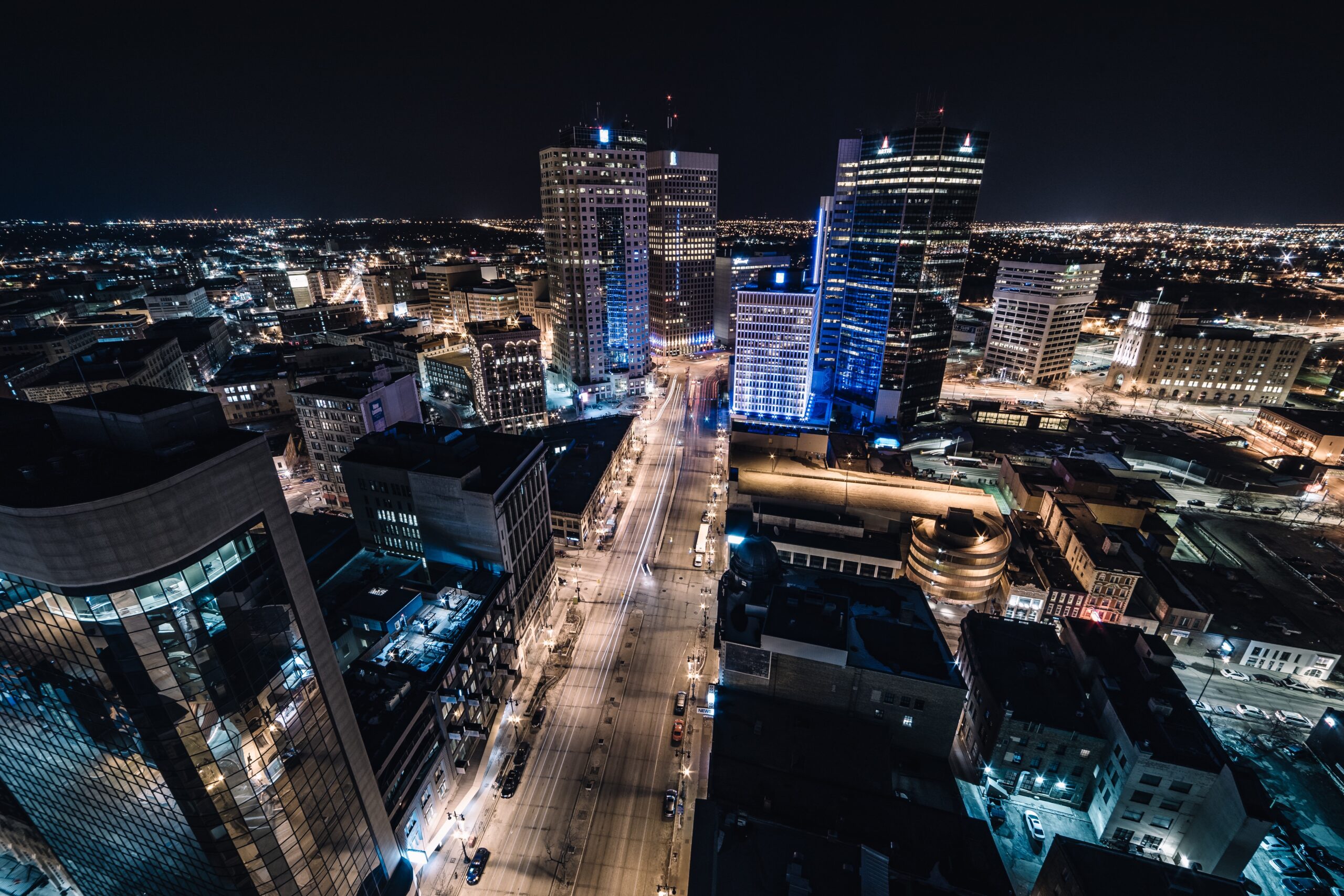 Aerial view of Winnipeg cityscape at night with illuminated buildings and streets.