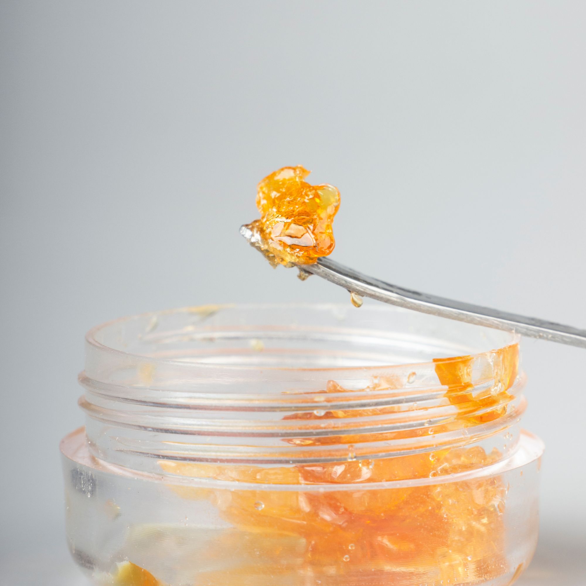Close-up of cannabis shatter on a dab tool, ready to be smoked.
